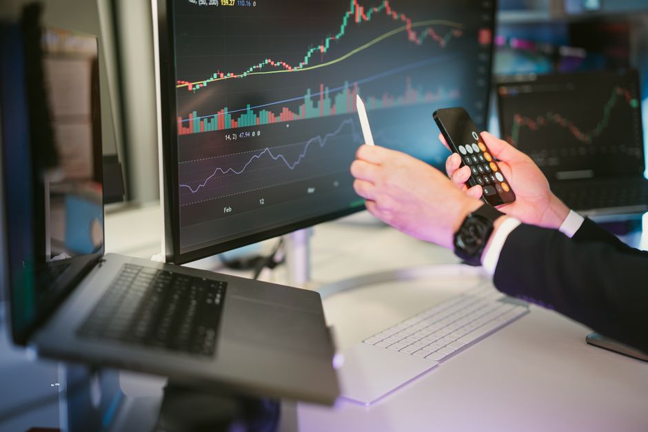 Professional in a modern, bright office analyzing complex data on a transparent digital screen, representing a data-first ...